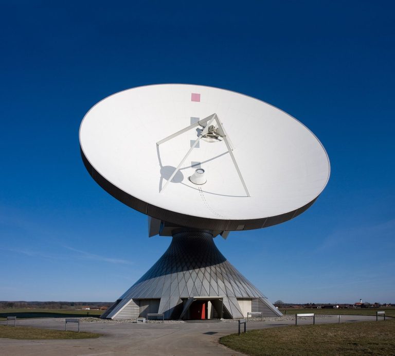 Photograph related to satellite broadband access, showing satellite dish rural landscape.